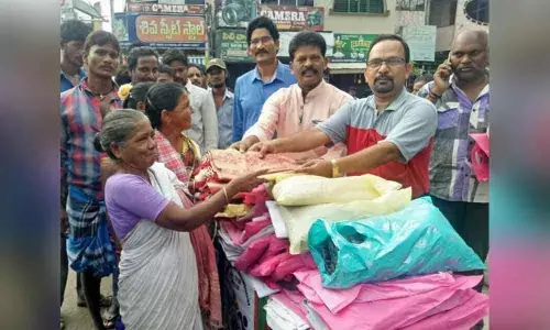 Swarnandhra distributes clothes to the poor in Rajamahendravaram