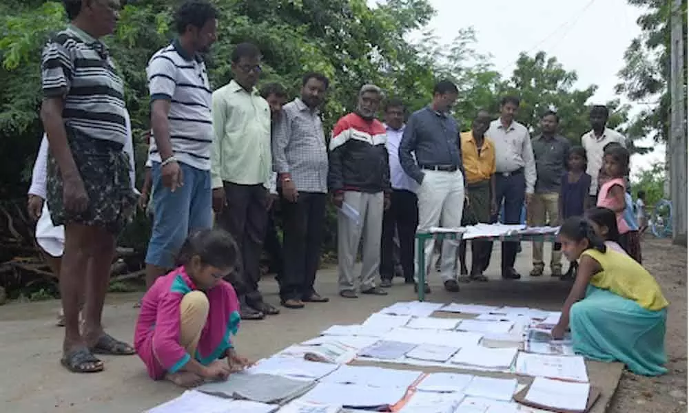 School students dry up their books after heavy downpour in Nalgonda