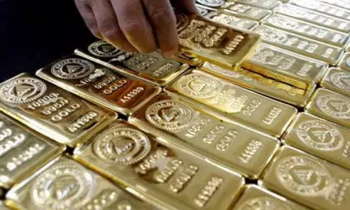 Gold drops by 215 on strong rupee