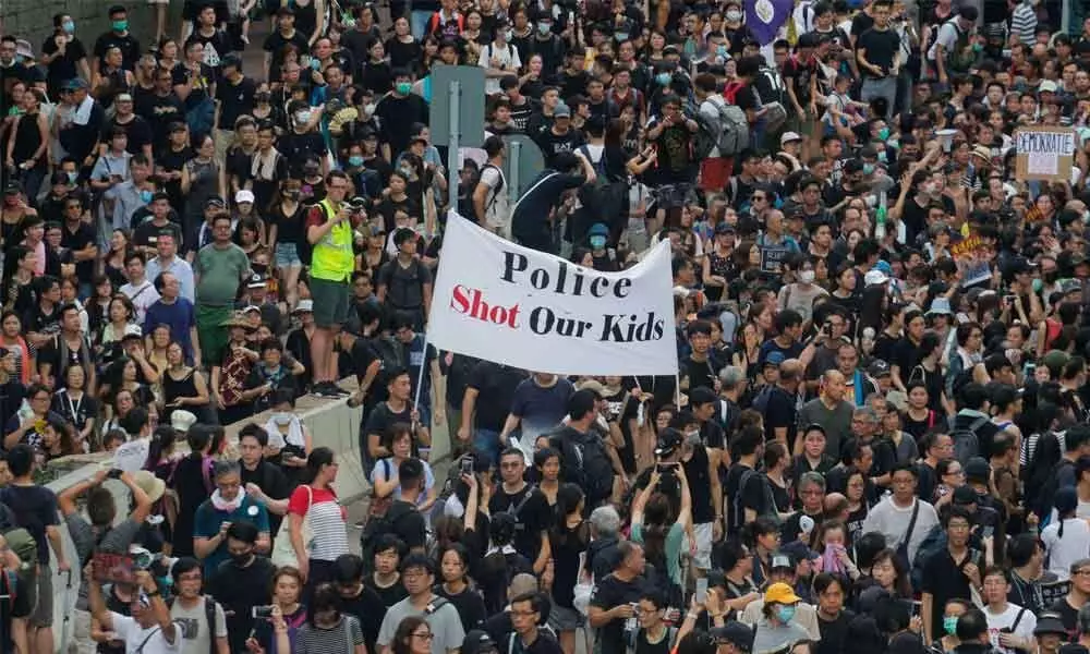 Demonstrators march in Hong Kong in new weekend of protest
