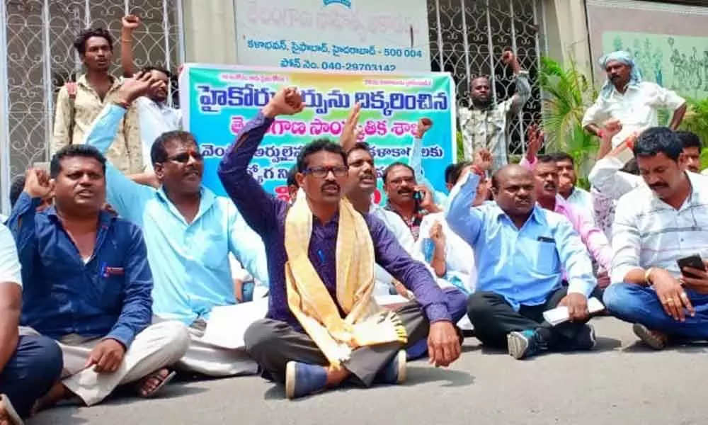 Artists stage dharna, demand recruitments