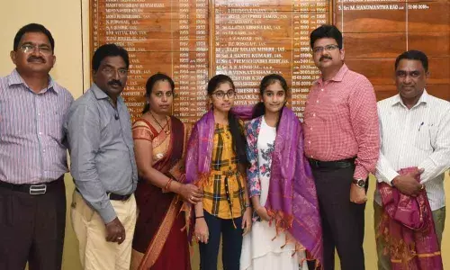 Sibilings donate savings for village