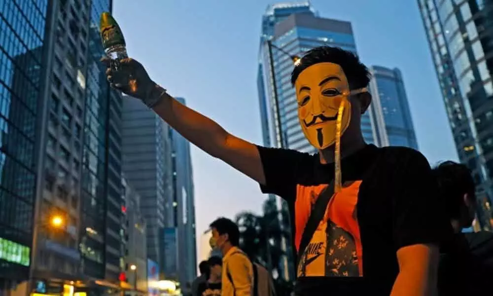 2 protesters charged in first use of Hong Kongs new mask ban