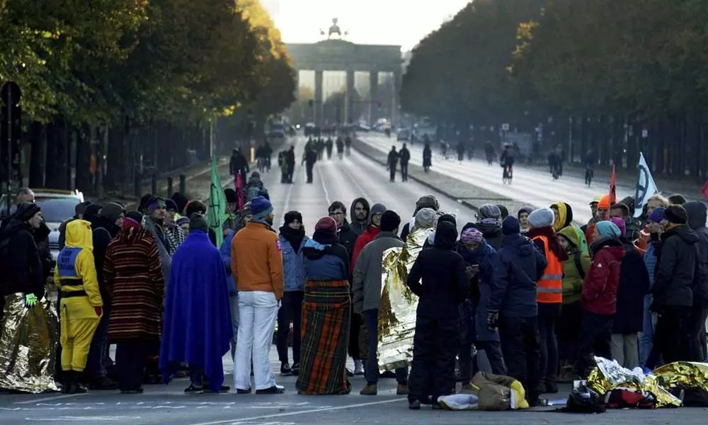 Protests to combat climate change block roads in European cities