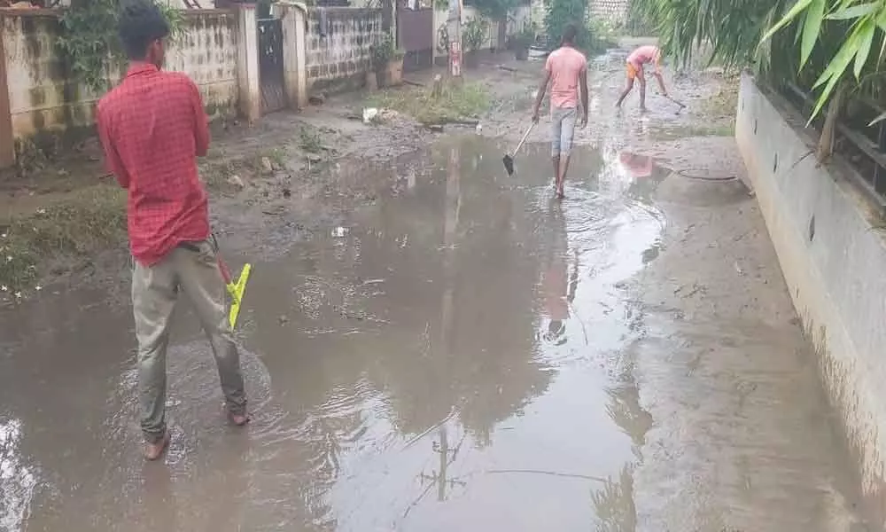 A vexed resident clears water-logging himself