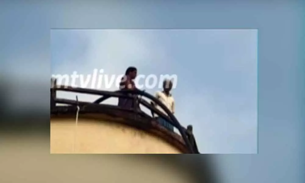 An Old Couple Climbs A Water Tank in Protest Against The Village Elders