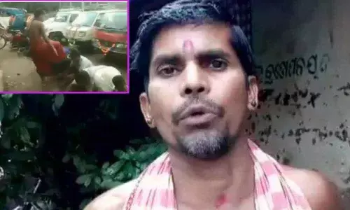 A shocking video of a priest in Odisha blessing his devotees with his feet on heads goes Viral