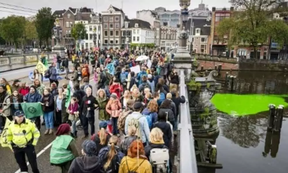 Dutch police arrest 130 climate protesters in Amsterdam