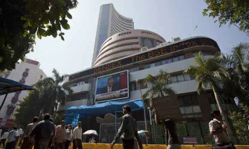 Markets end in green amid volatility