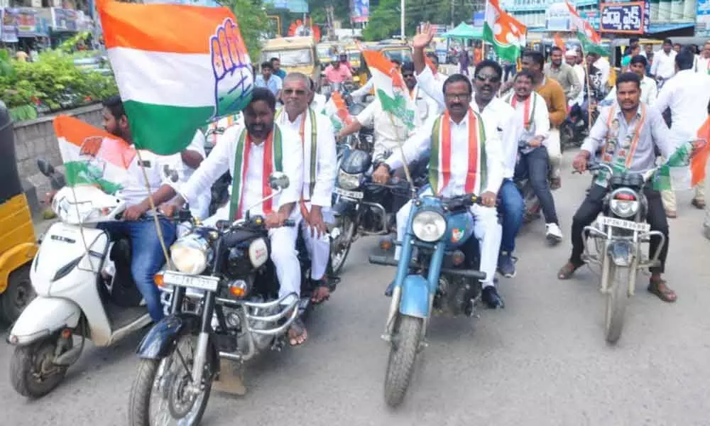 Congress party leaders and members taking out a bike rally in Khammam town on Friday