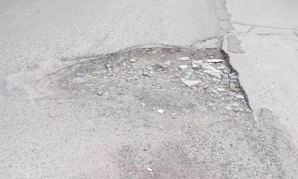 Pot-holed road posing risks