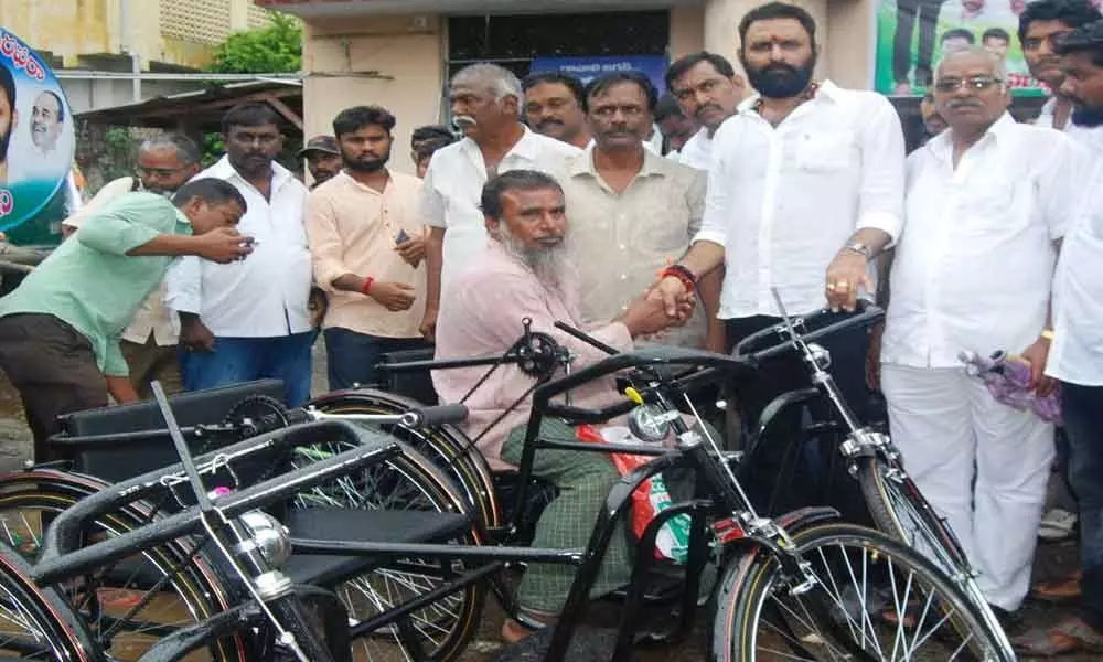 Minister distributes tricycles to handicapped in Gudivada
