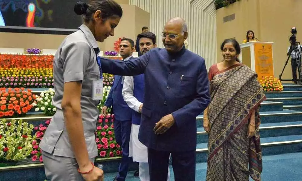 President Ram Nath Kovind attends to a policewoman who fell down during national anthem