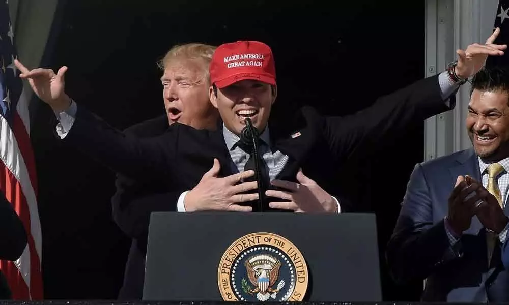 In pictures: Donald Trump awkwardly hugs Baseball champion at the White House