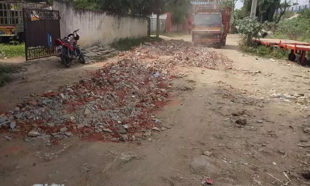Locals irked as waste dumped on road