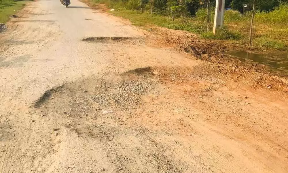 Road riddled with potholes