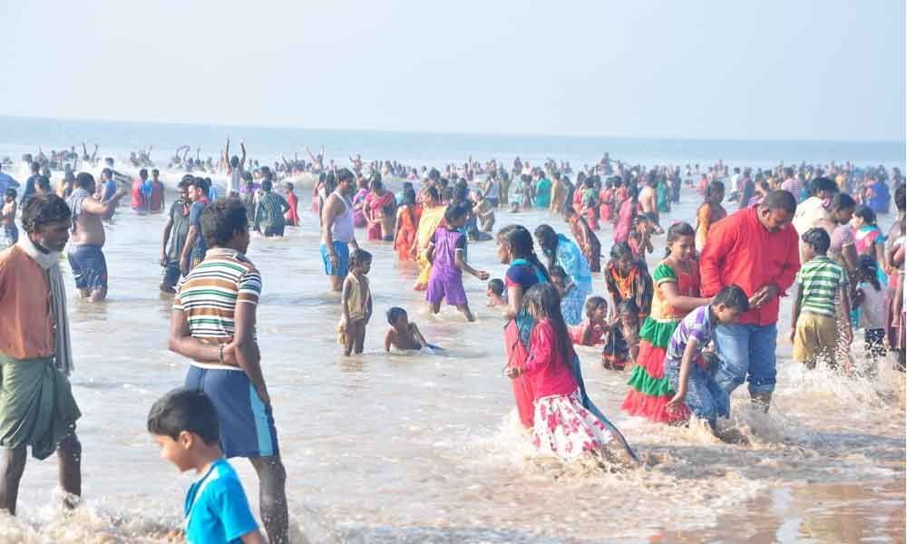 Guntur: Devotees Offer Prayers On Karthika Purnima At Suryalanka Beach