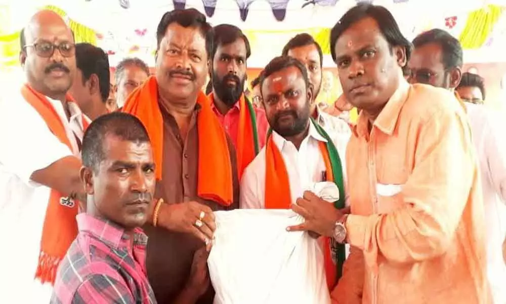 BJP leaders distribute rations to RTC workers