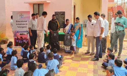 Bayers distributes school bags to students