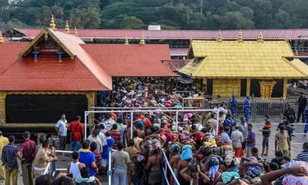 Devotees brave rain to offer prayers at Sabarimala