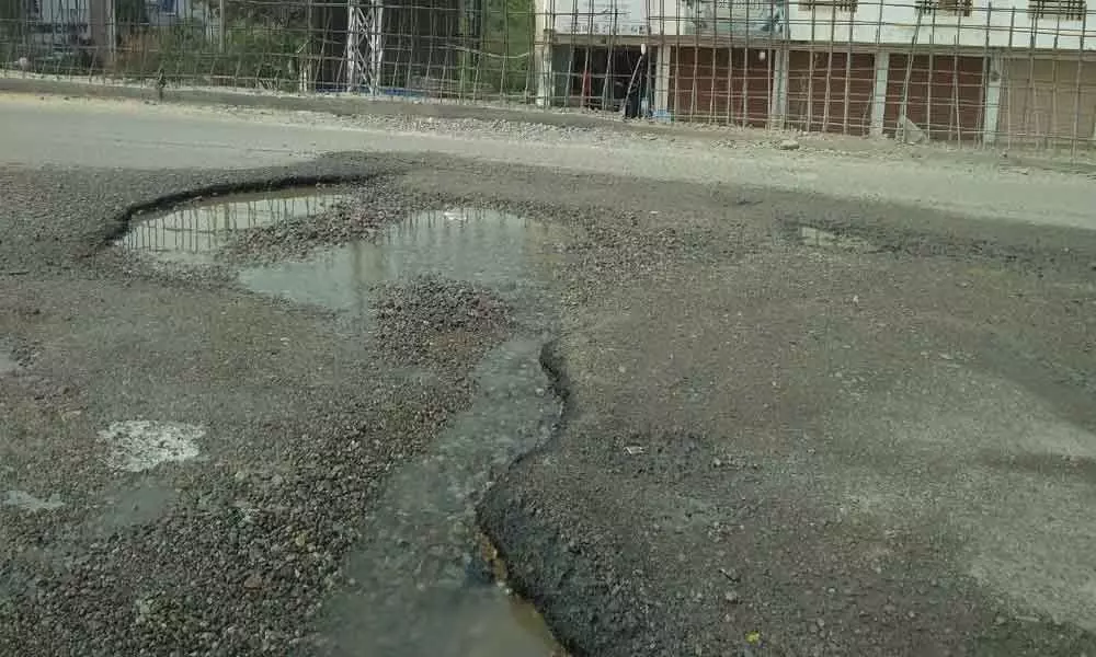 Road lies badly potholed at Nallagandla