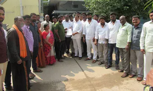MLA Bethi Subhash Reddy handing over a CMRF cheque at Bhavani Nagar