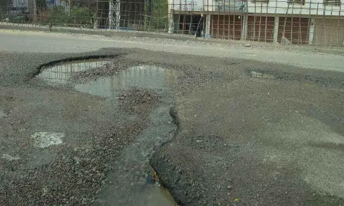 Road lies badly potholed at Nallagandla