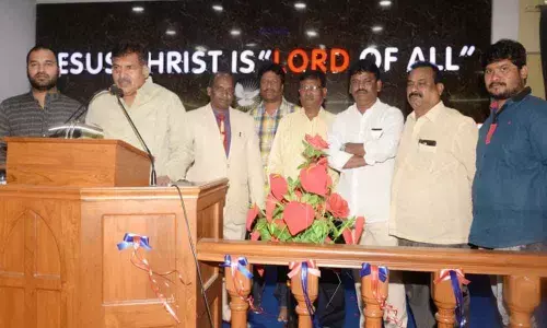 MLA Muta Gopal helps lay flooring at church