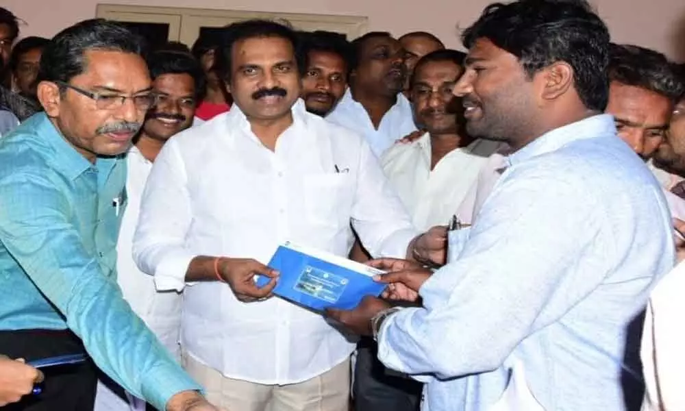 Minister Kurasala Kannababu distributes smart cards to fishermen in Kakinada