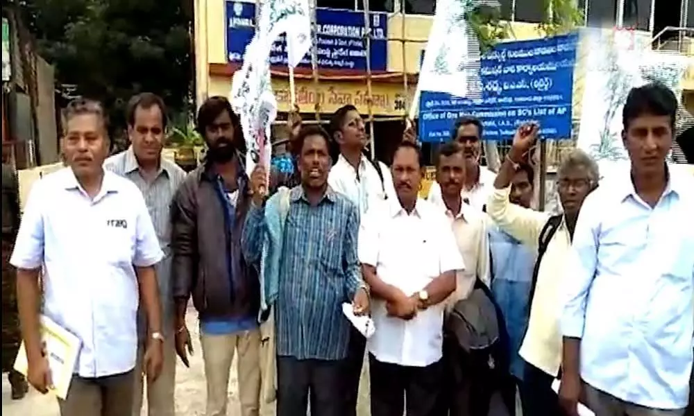 Sugarcane farmers protest in front of Commissioner office at Tadepalli in demand of payment of their dues