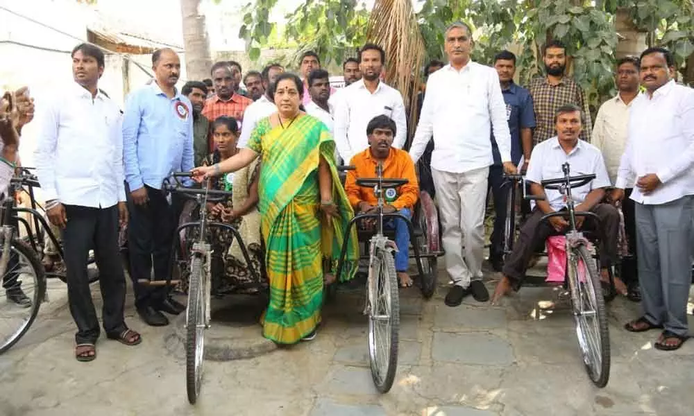 Tricycles distributed to disabled