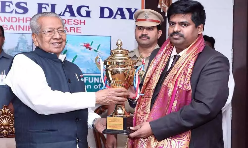 Flag Day fund collections: Governor felicitates Collector Muthyala Raju