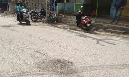 Potholed road has no streetlights