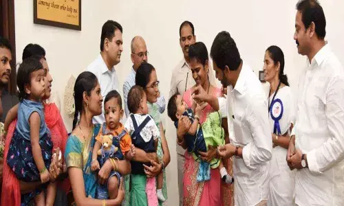 CM YS Jagan Mohan Reddy administers polio drops to kids at Tadepalli in Guntur
