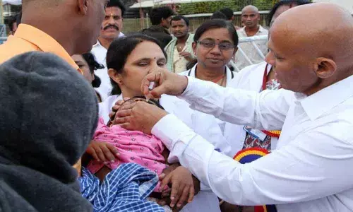 TTD EO Dharma Reddy administers polio drops to children in Tirumala