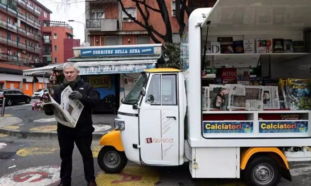 This 52-year-old and his three-wheeler are fighting for the future of newspapers