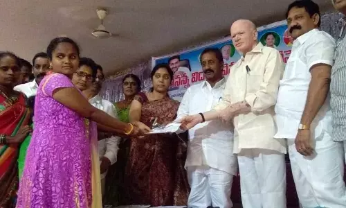Dy CM Pilli Subhash Chandra Bose distributes Vidya Deevena cards