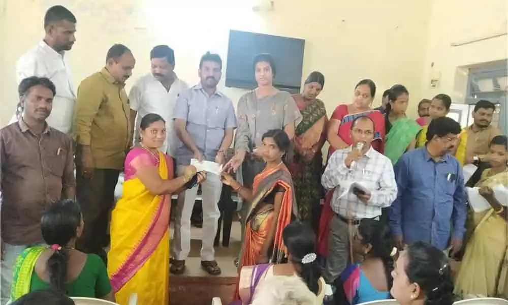 MLA Dr Methuku Anand presents cheques to beneficiaries