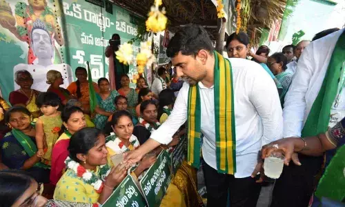 Nara Lokesh offering lemon juice to women farmers