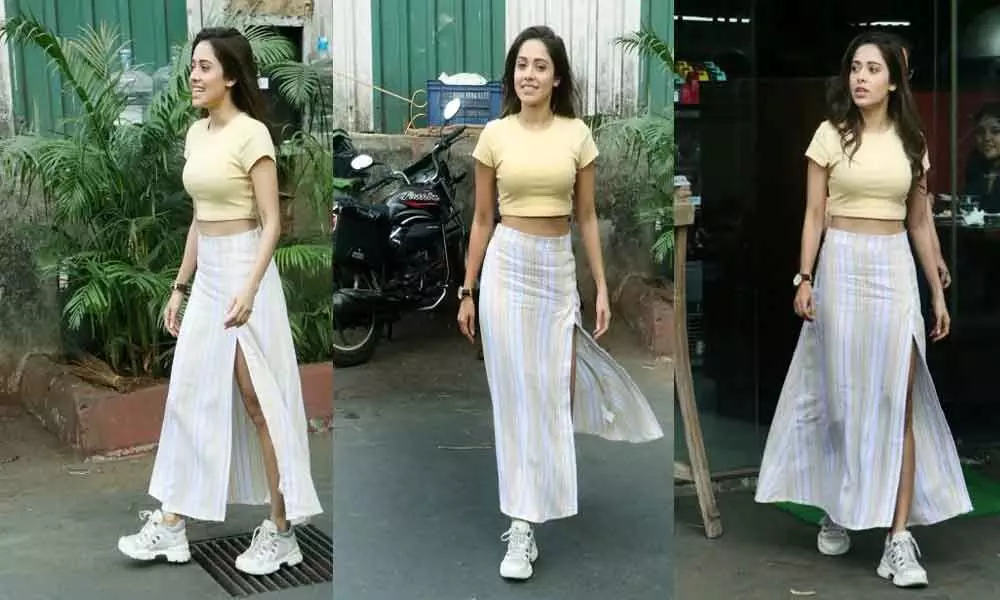 Nushrat Bharucha was spotted on a yellow crop top and a trending thigh-slit skirt in Mumbai