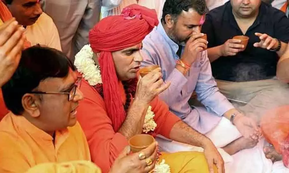 Swami thirsty for publicity drinks cow urine at Delhi party