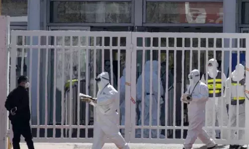 China reports 14 new coronavirus deaths; imported cases rise to 123