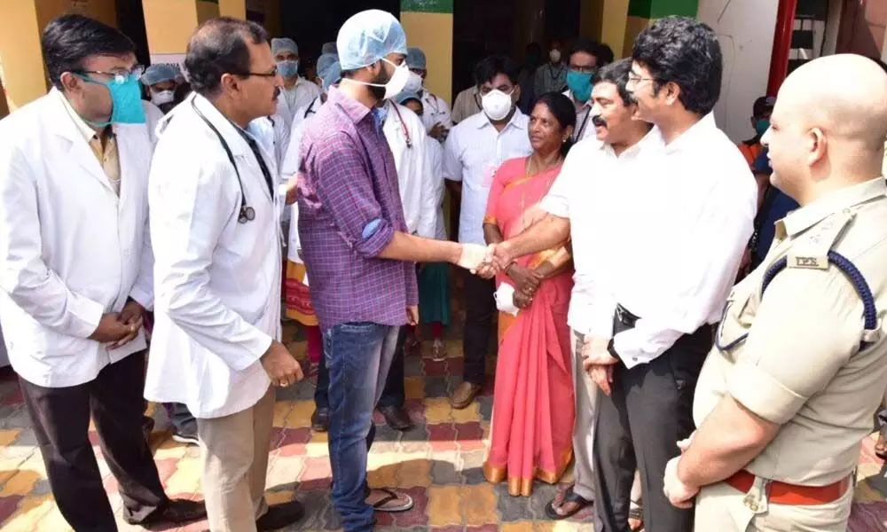 Andhra Pradesh officials shake hands with Coronavirus recovered patient