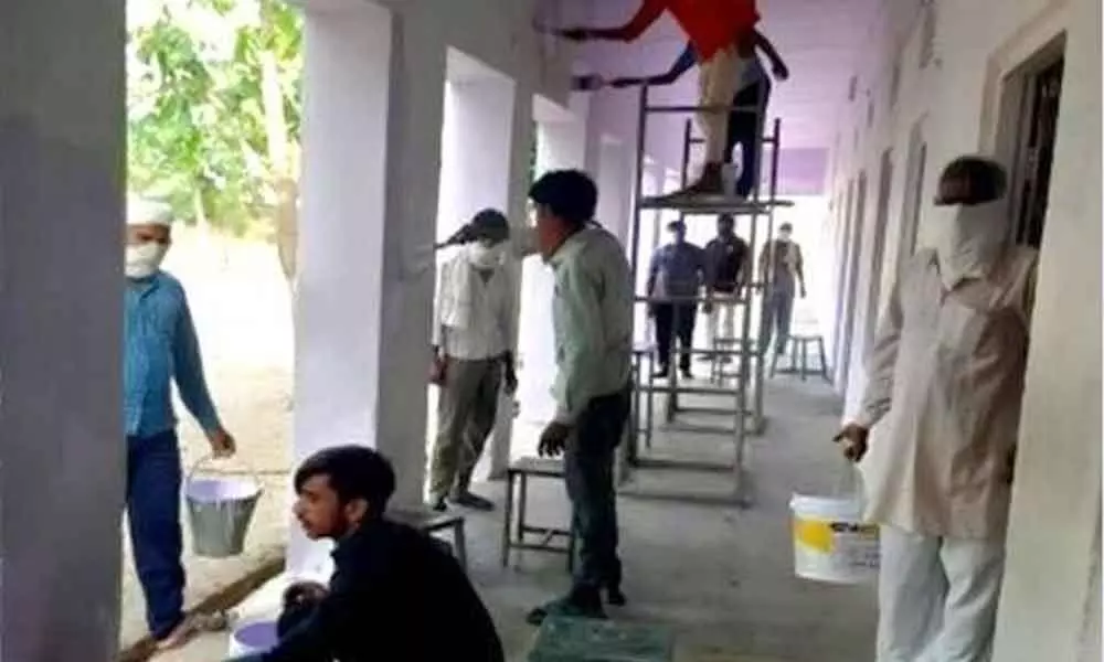 Quarantined migrant workers give new look to school building