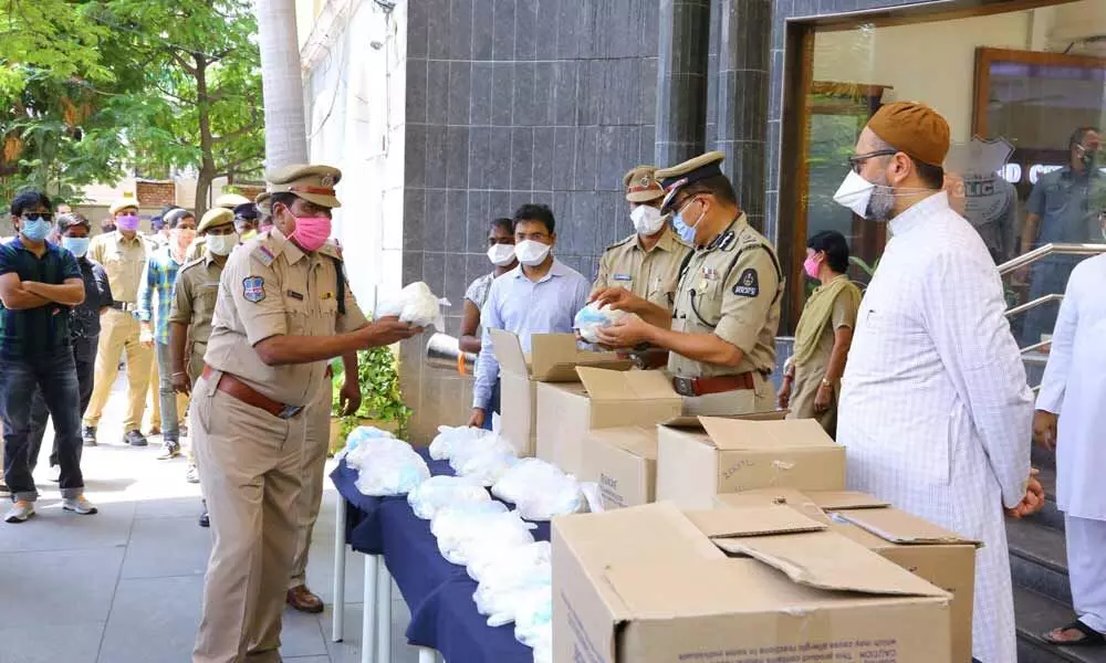 Hyderabad MP Asaduddin Owaisi hands over safety kits to CP Anjani Kumar