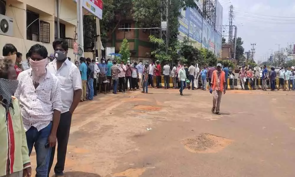 After a long wait, tipplers in large number flock to liquor stores in Visakhapatnam