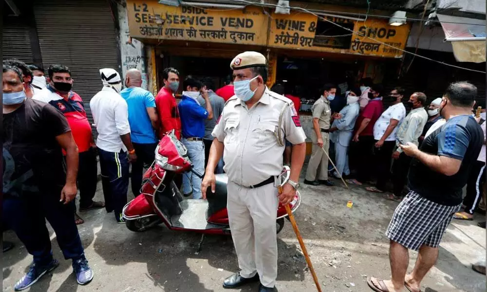 Indians queue for liquor as Delhi eases some coronavirus curbs