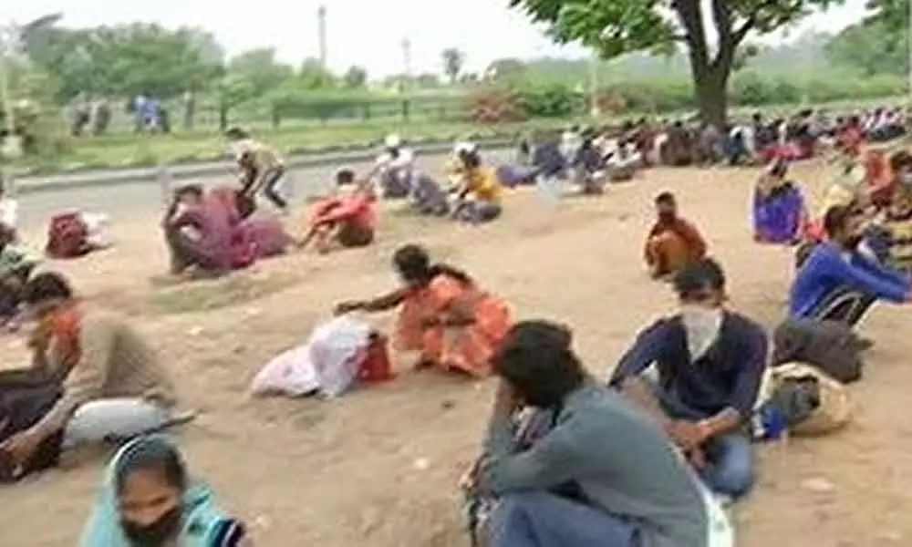 Migrants sit-in at highway, demand transport home