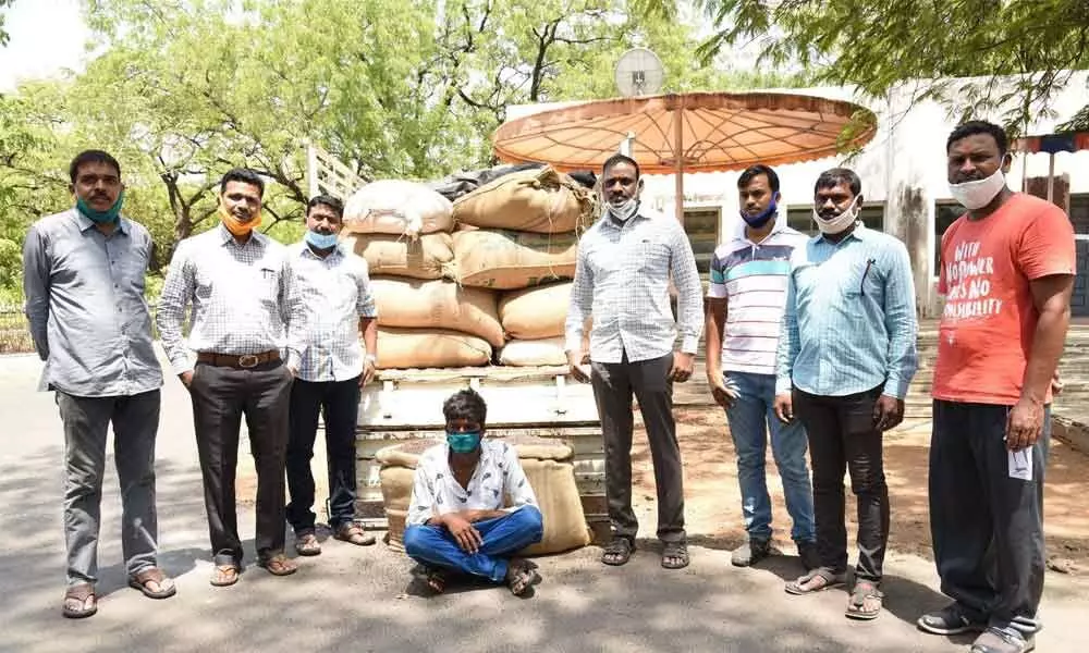 Task force officials along with the driver of the seized vehicle and fake seeds in Karimnagar on Thursday