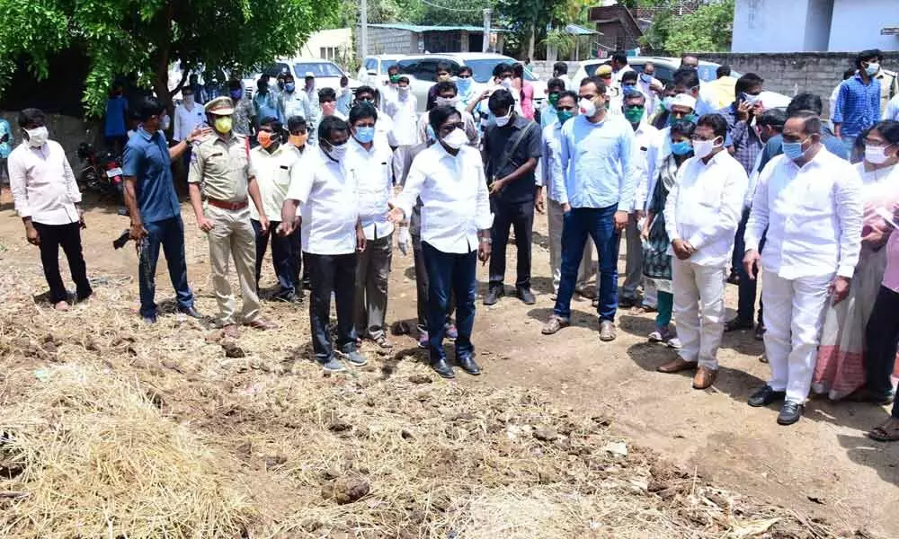 Transport Minister P Ajay Kumar questioning the officials over garbage pile beside a road in Kondakodima village on Monday